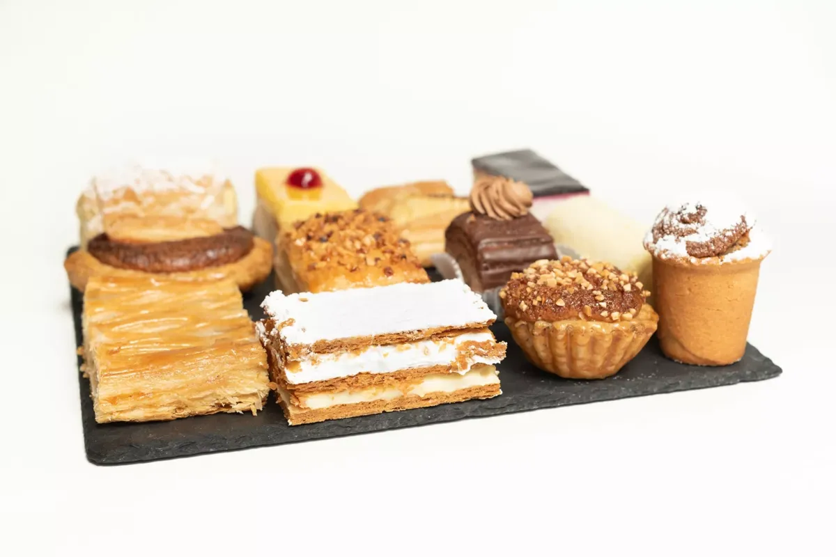 Bandeja con variedad de pasteles de Pastelería el Fontán en Tineo